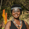 African lady wearing matching headband, necklace and earrings