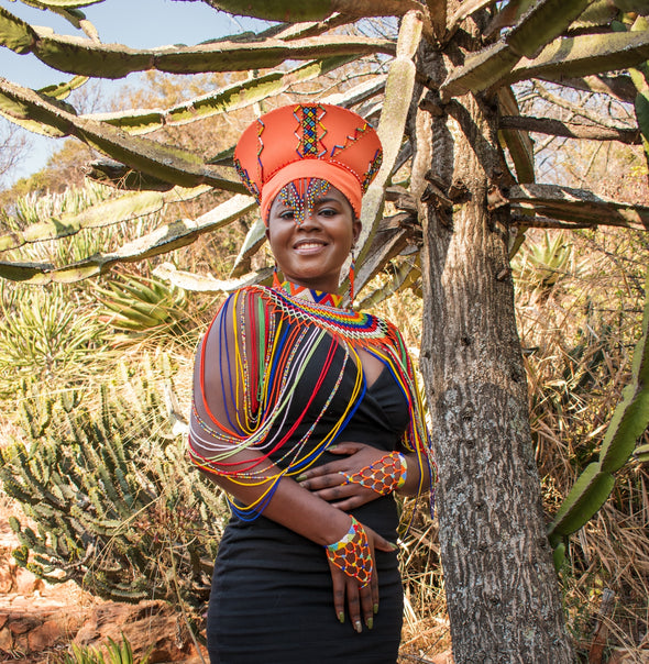 Smiling African lady wearing African beaded jewellery.