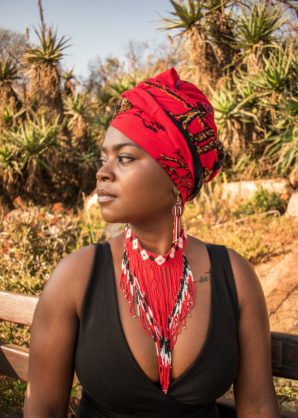 African ladey wearing matching head shawl, Zulu beaded earrings and neclace