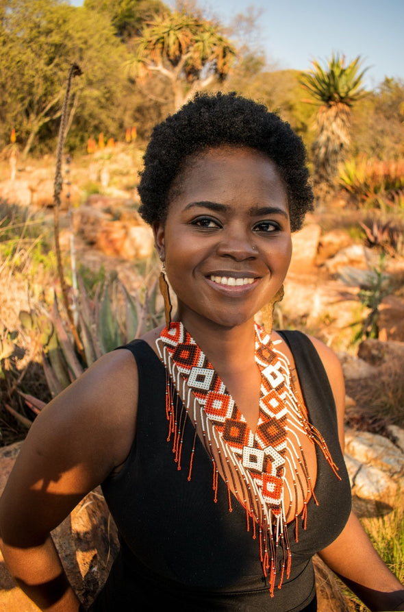 African lady wearing a beautiful Zulu necklace